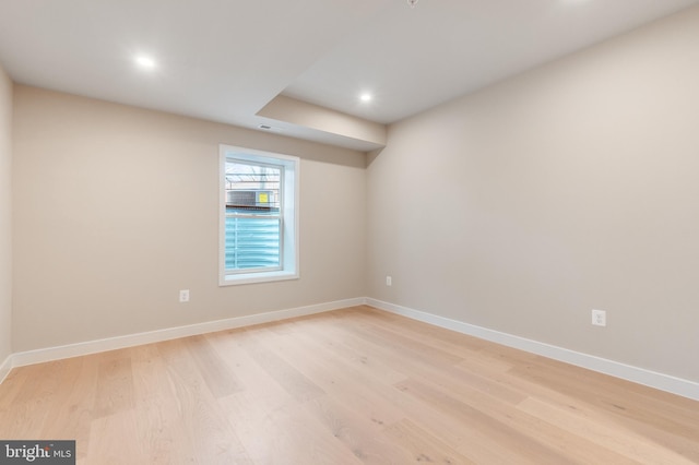 spare room featuring light wood-style floors, visible vents, baseboards, and recessed lighting