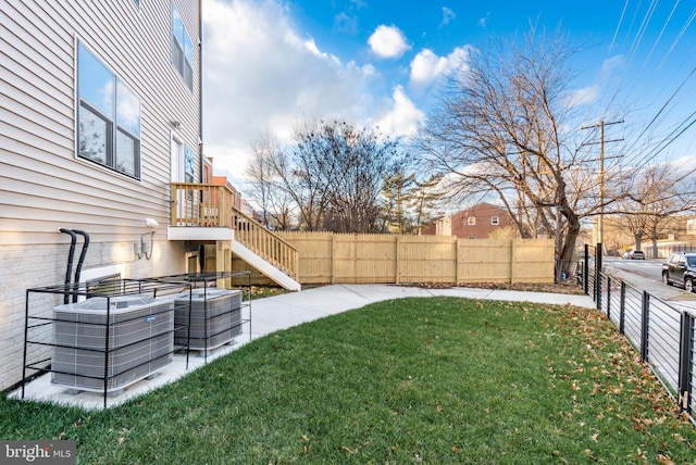 view of yard with cooling unit and a fenced backyard