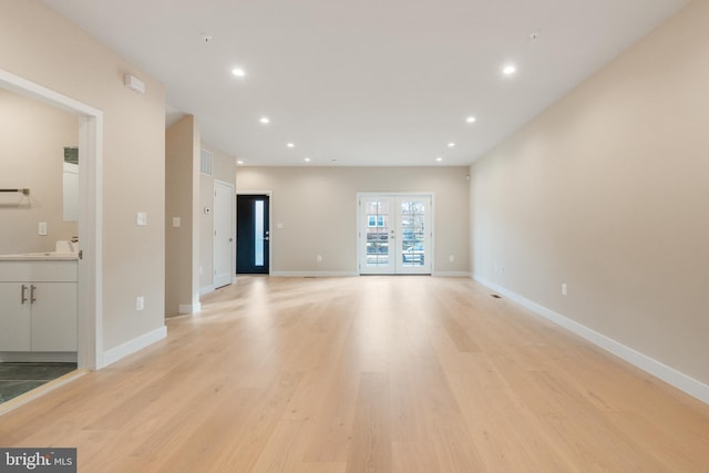 unfurnished living room with baseboards, recessed lighting, visible vents, and light wood-type flooring