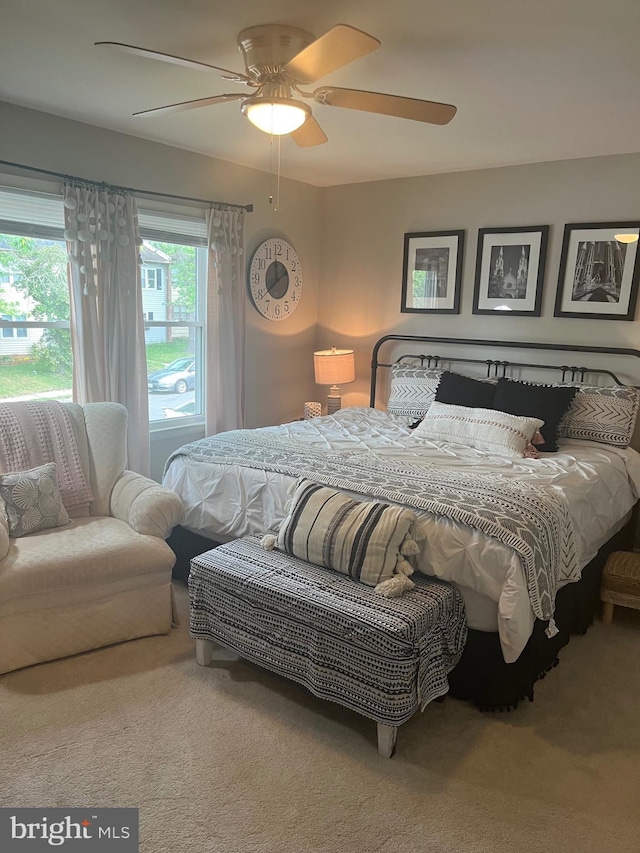 bedroom with ceiling fan and carpet floors