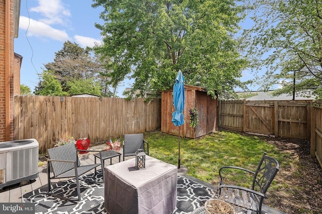 view of yard with central AC, a shed, an outdoor structure, and a patio