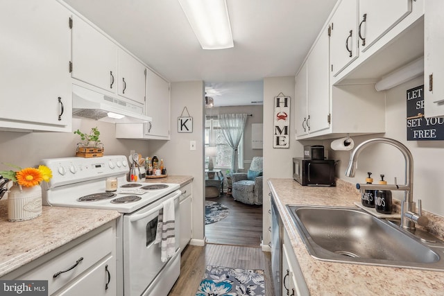 kitchen featuring white electric range oven, under cabinet range hood, a sink, wood finished floors, and light countertops