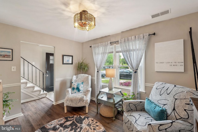 living area featuring wood finished floors, stairway, and baseboards