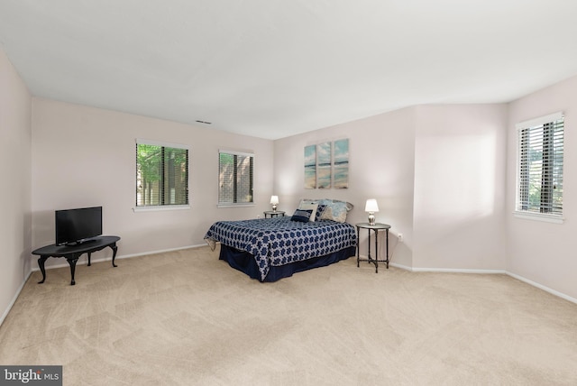 carpeted bedroom featuring baseboards