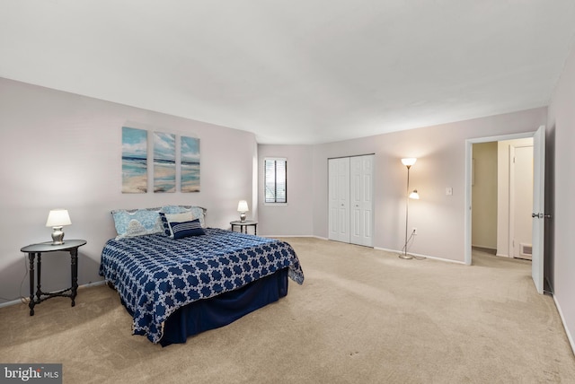 carpeted bedroom with baseboards and a closet
