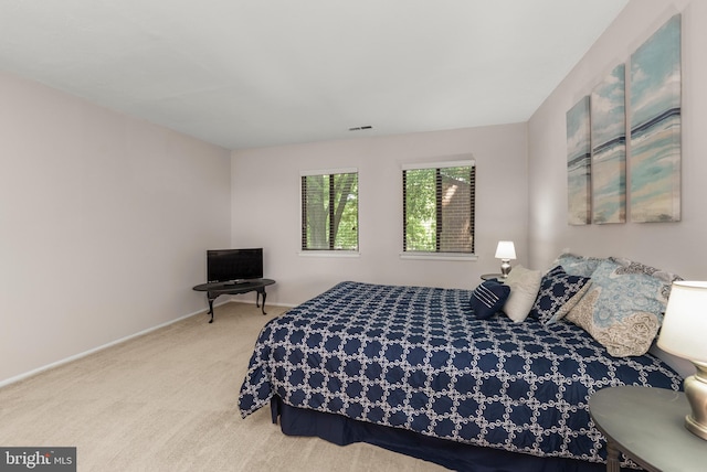 carpeted bedroom featuring baseboards
