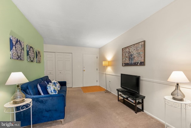 living room featuring carpet and baseboards