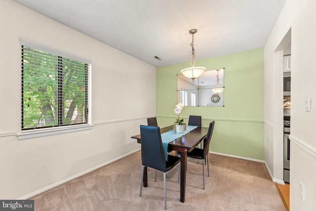 dining space featuring healthy amount of natural light, carpet floors, and baseboards