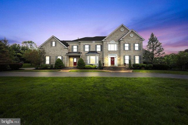 view of front of property with a yard and stone siding