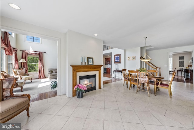 dining area featuring a glass covered fireplace, light tile patterned floors, and recessed lighting