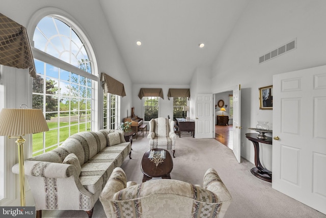 carpeted living room with plenty of natural light, high vaulted ceiling, and recessed lighting