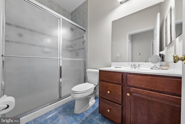 full bath featuring tile patterned flooring, a stall shower, toilet, and vanity