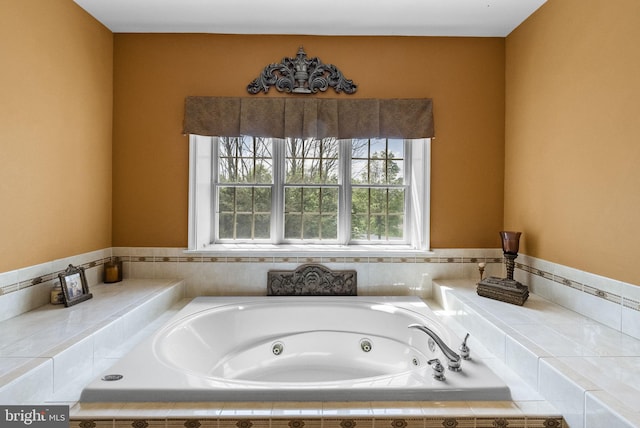 bathroom with a tub with jets