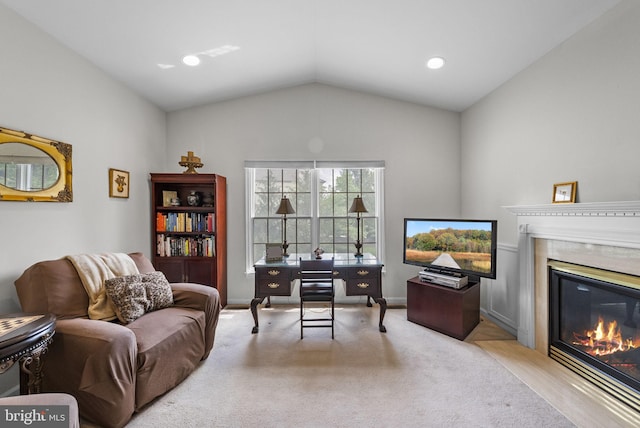 carpeted living room with vaulted ceiling, a fireplace, and baseboards