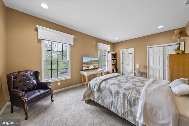 carpeted bedroom featuring baseboards, recessed lighting, and a closet