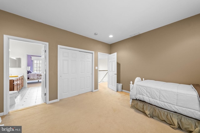 bedroom with light carpet, baseboards, a sink, and a closet
