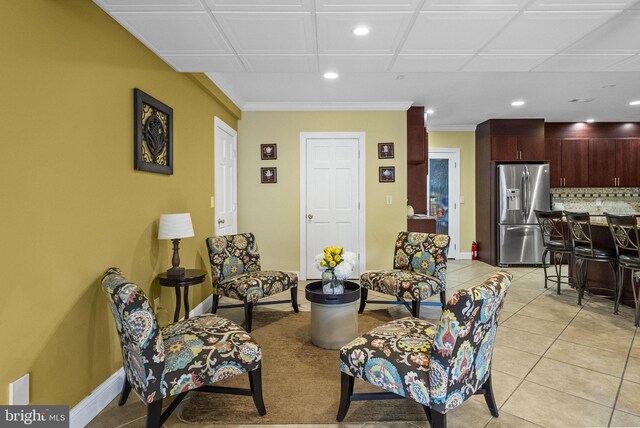 living room with recessed lighting, baseboards, and light tile patterned floors