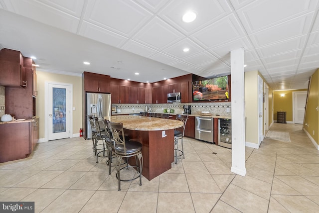 kitchen featuring stainless steel appliances, wine cooler, backsplash, light tile patterned floors, and recessed lighting