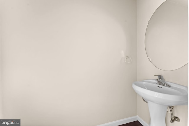 bathroom featuring baseboards and wood finished floors