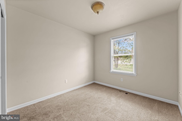 unfurnished room with carpet floors and baseboards