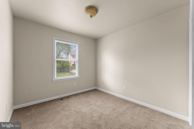 empty room with carpet floors and baseboards