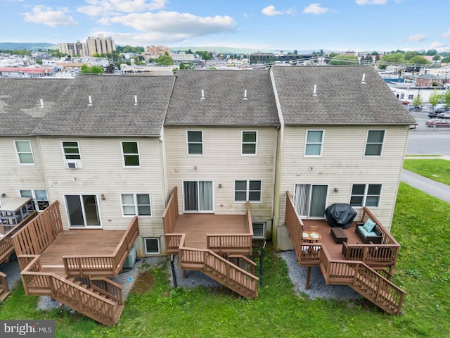 rear view of property featuring stairs, a wooden deck, and a yard