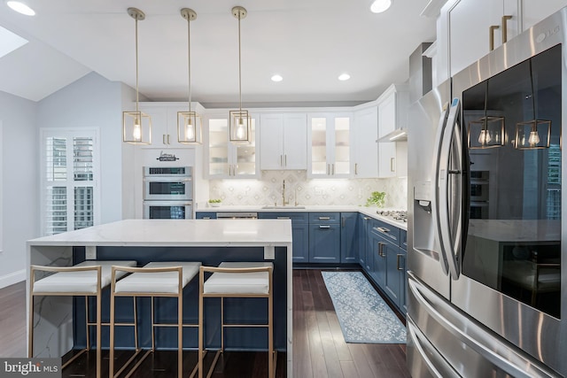 19599 Aspendale Sq, Ashburn, VA 20147 - kitchen featuring appliances with stainless steel finishes, blue cabinetry, dark wood finished floors, a sink, and recessed lighting