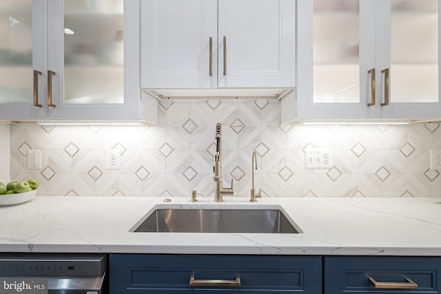 19599 Aspendale Sq, Ashburn, VA 20147 - kitchen featuring a sink, stainless steel dishwasher, white cabinetry, blue cabinets, and glass insert cabinets