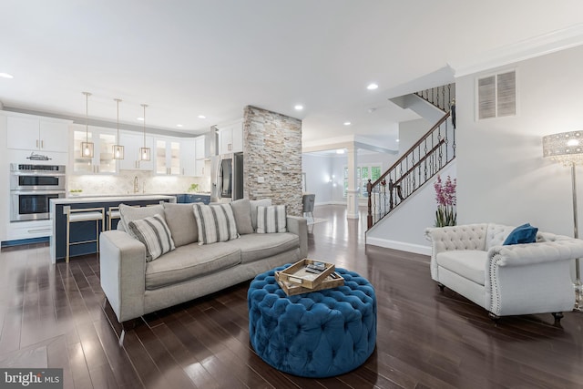 19599 Aspendale Sq, Ashburn, VA 20147 - living area featuring stairs, dark wood-type flooring, baseboards, crown molding, and recessed lighting