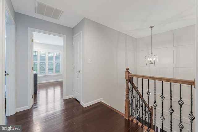 19599 Aspendale Sq, Ashburn, VA 20147 - hall with an upstairs landing, dark wood-style floors, a chandelier, and baseboards