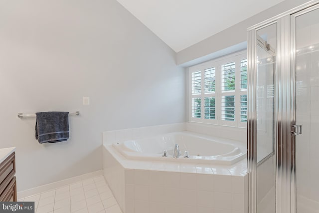 19599 Aspendale Sq, Ashburn, VA 20147 - bathroom featuring lofted ceiling, a garden tub, a stall shower, vanity, and tile patterned flooring