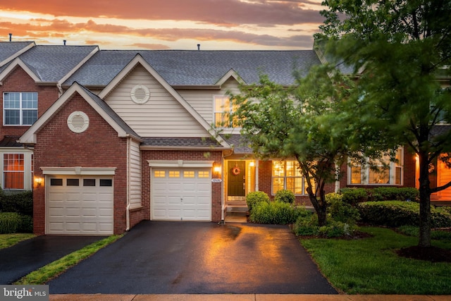 19599 Aspendale Sq, Ashburn, VA 20147 - view of front of house featuring driveway, brick siding, a garage, and a shingled roof