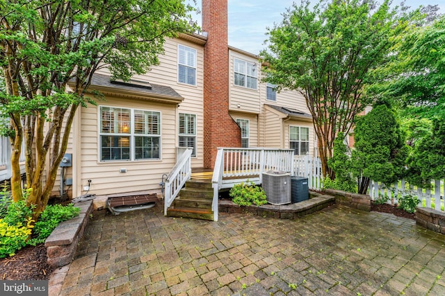 19599 Aspendale Sq, Ashburn, VA 20147 - rear view of house featuring a patio area, a deck, central air condition unit, and a chimney
