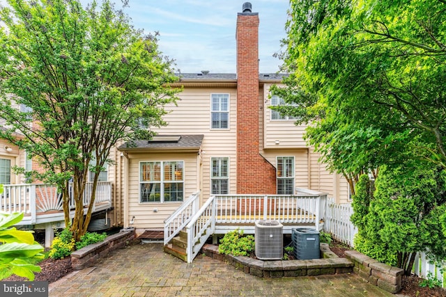 19599 Aspendale Sq, Ashburn, VA 20147 - back of house featuring a deck, cooling unit, and a patio