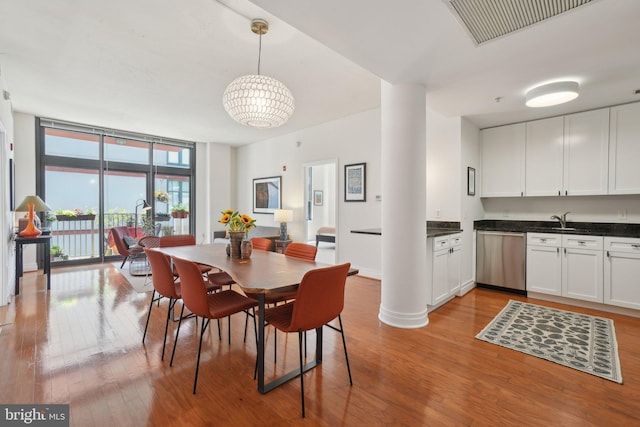 2120 Vermont Ave NW Unit 309, Washington, DC 20001 - dining space with light wood-style floors and floor to ceiling windows