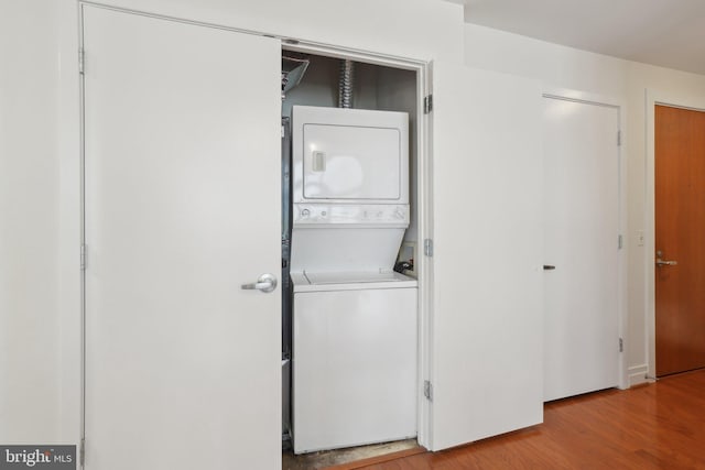 2120 Vermont Ave NW Unit 309, Washington, DC 20001 - laundry room with stacked washing machine and dryer and light wood-style floors