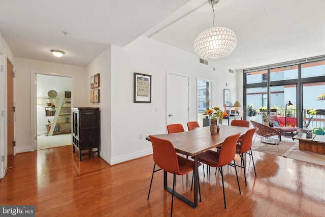 2120 Vermont Ave NW Unit 309, Washington, DC 20001 - dining space featuring wood finished floors and a wall of windows
