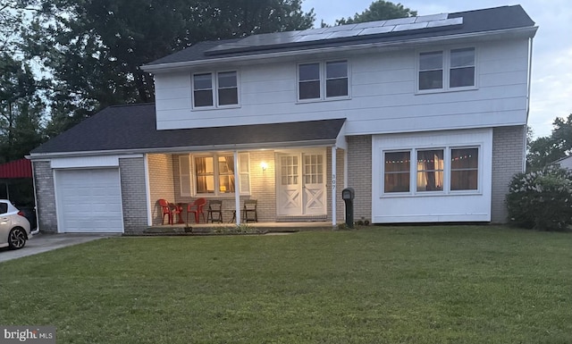 307 Congress Dr, Gibbstown, NJ 08027 - view of front of home with brick siding, a porch, an attached garage, roof mounted solar panels, and a front yard