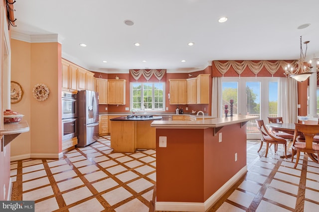 kitchen with an inviting chandelier, recessed lighting, light brown cabinets, and appliances with stainless steel finishes