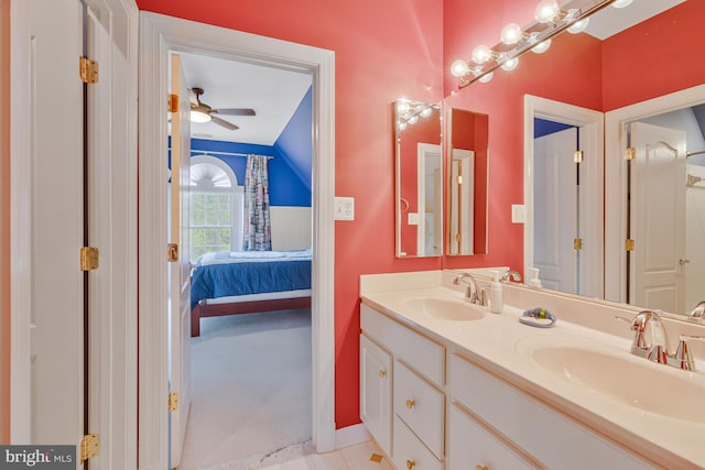 ensuite bathroom with a sink, double vanity, ensuite bathroom, and ceiling fan