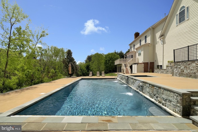 pool with a deck and stairway
