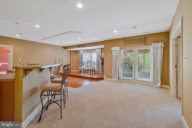 bar with light colored carpet, baseboards, and recessed lighting