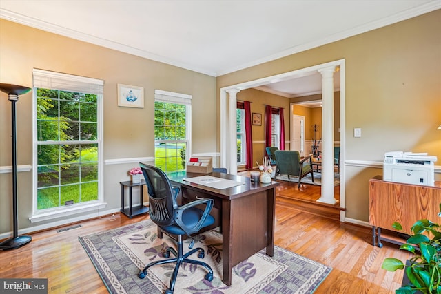 home office featuring ornate columns, ornamental molding, wood finished floors, and baseboards