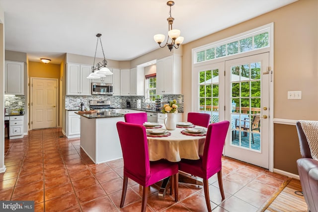 dining area featuring a chandelier and light tile patterned floors