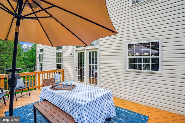 wooden terrace featuring outdoor dining space