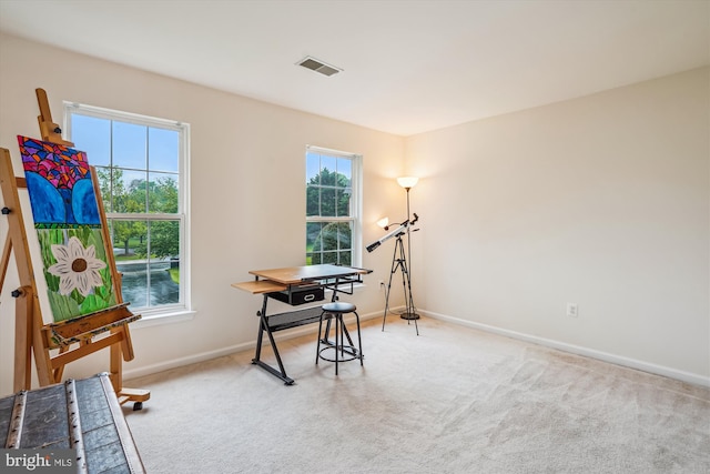 home office with baseboards and light colored carpet