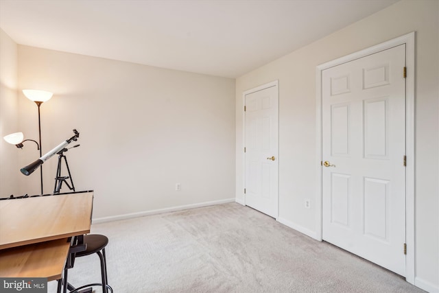unfurnished office featuring carpet floors and baseboards