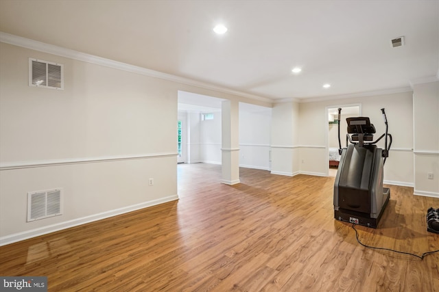 exercise area with crown molding, wood finished floors, recessed lighting, baseboards, and decorative columns