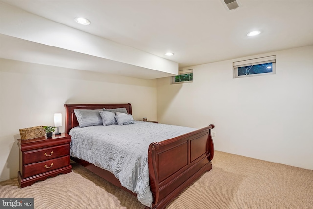 bedroom featuring light carpet and recessed lighting