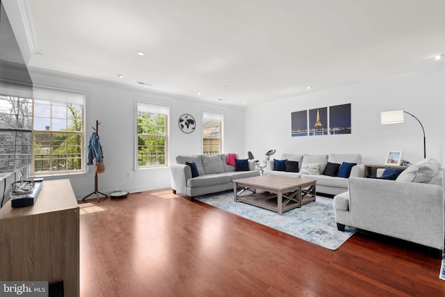 living area with ornamental molding, dark wood-type flooring, recessed lighting, and baseboards